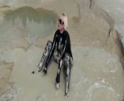 Super Hot Blond Girl In Black Latex Catsuit + High Heels And Sunglasses Bathes In The Mud - Mud Bath from mud
